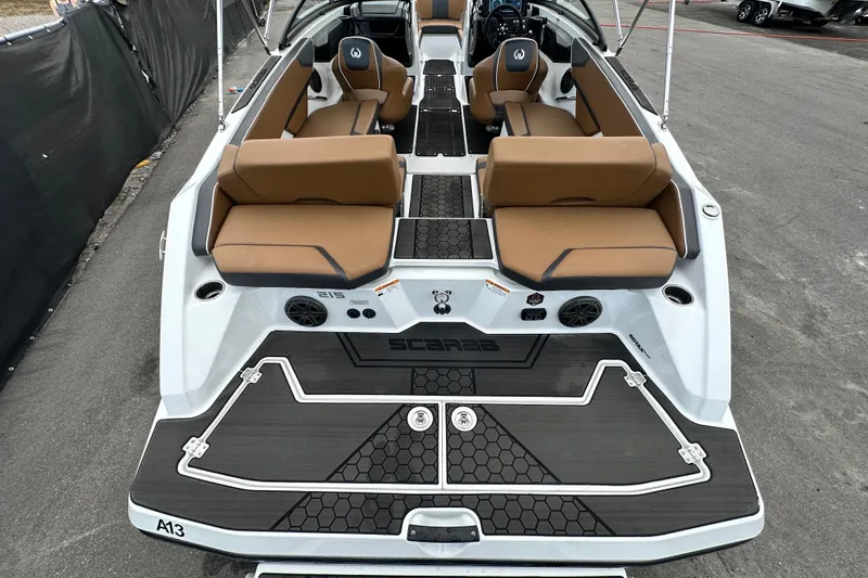 Slide: The Image of 2023 Scarab 215 ID boat with tan seating and modern design on display. - 70