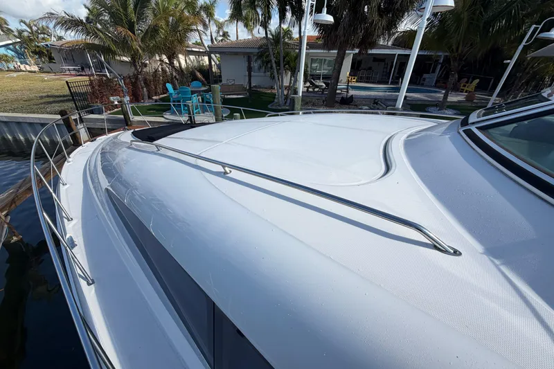 Slide: The Image of 2002 Sea Ray 480 Motor Yacht docked near tropical garden setting. - 10