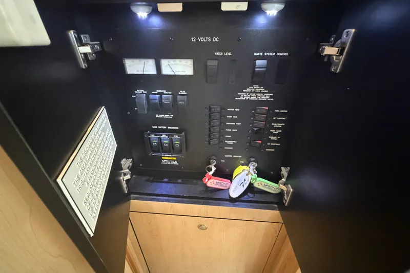 Slide: The Image of Electrical control panel inside 2002 Sea Ray 480 Motor Yacht, featuring switches and gauges. - 33