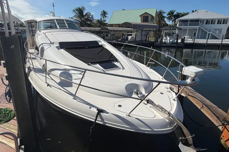 Slide: The Image of 2002 Sea Ray 480 Motor Yacht docked at marina, sunny day, palm trees in background. - 4