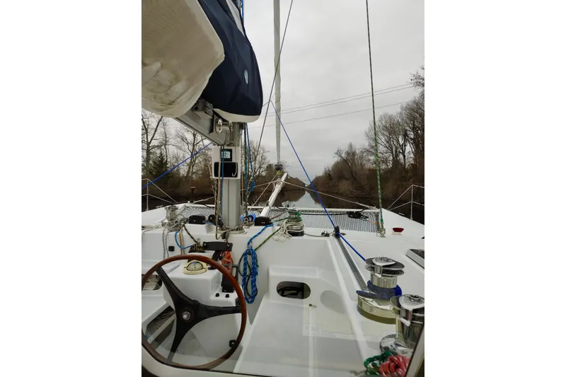 Slide: The Image of Sailing deck of 2003 Chris White Atlantic 42 catamaran on a calm waterway. - 12