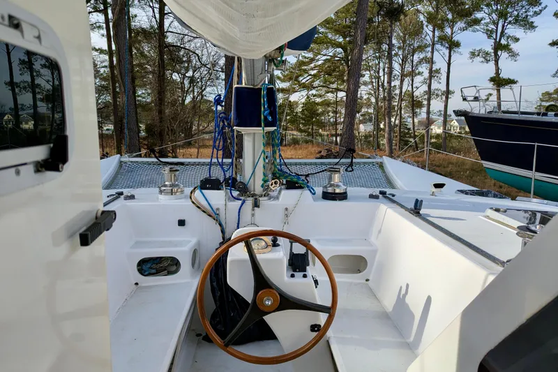 Slide: The Image of Cockpit of 2003 Chris White Atlantic 42 catamaran with wooden steering wheel and rigging. - 17