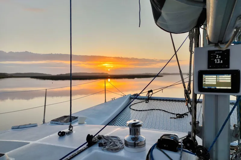 Slide: The Image of Sailing on Chris White Atlantic 42 at sunset, 2003 model, serene waterscape. - 25