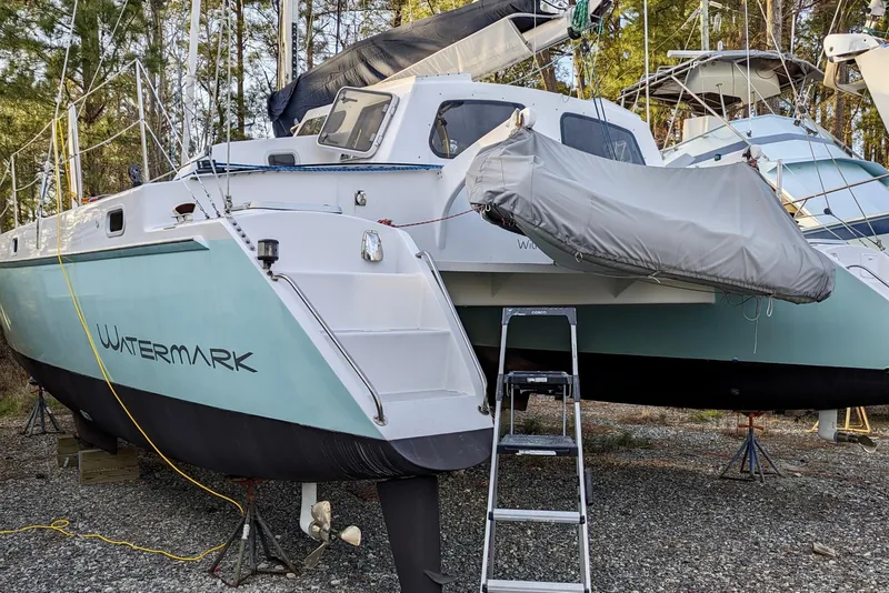 Slide: The Image of 2003 Chris White Atlantic 42 catamaran "Watermark" on land, with dinghy and ladder. - 27