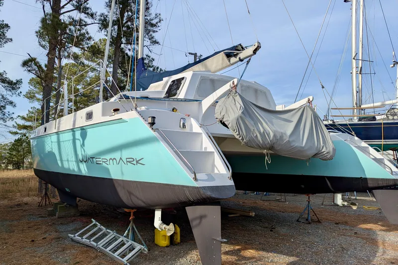 Slide: The Image of 2003 Chris White Atlantic 42 catamaran "Watermark" on land, surrounded by trees. - 28