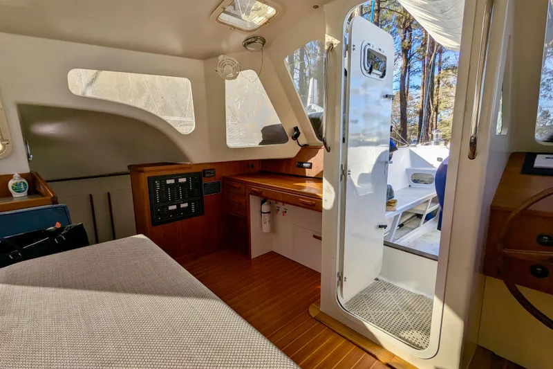 Slide: The Image of Interior of 2003 Chris White Atlantic 42 yacht, featuring wood accents and open door to deck. - 31