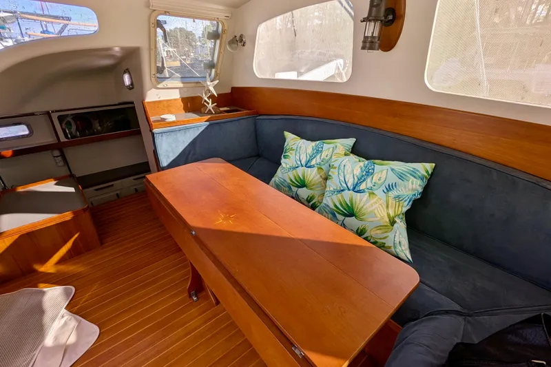 Slide: The Image of Interior of 2003 Chris White Atlantic 42 yacht with wooden table and tropical cushions. - 35
