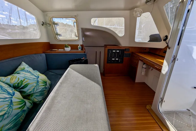 Slide: The Image of Interior of 2003 Chris White Atlantic 42 yacht with cozy seating and wooden accents. - 36
