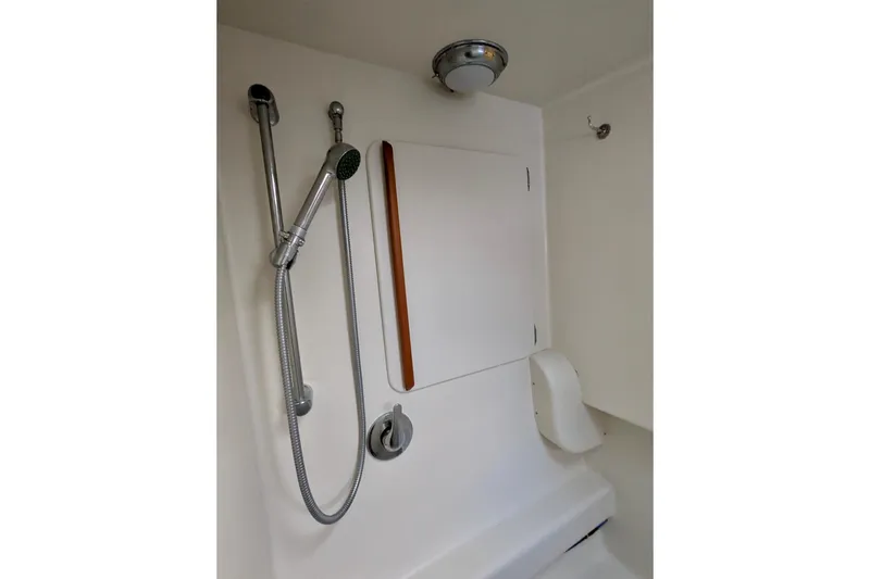 Slide: The Image of Shower area in 2003 Chris White Atlantic 42 yacht, featuring handheld showerhead and white interior. - 41