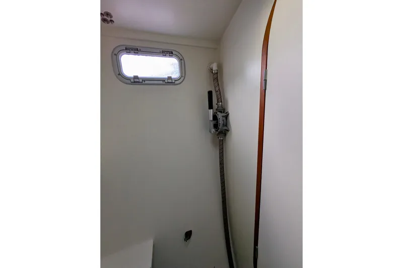 Slide: The Image of Interior of 2003 Chris White Atlantic 42 yacht, featuring a porthole and plumbing fixtures. - 42