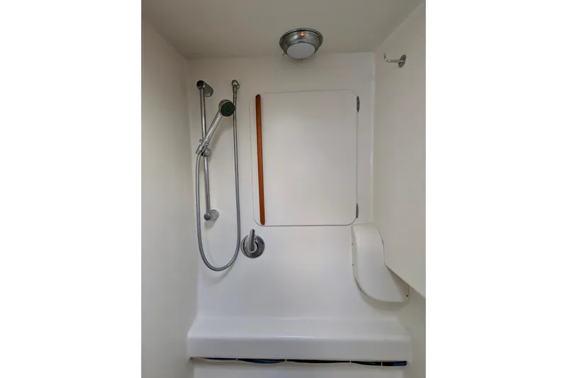 Slide: The Image of Shower area in 2003 Chris White Atlantic 42 yacht, featuring handheld showerhead and storage compartment. - 45