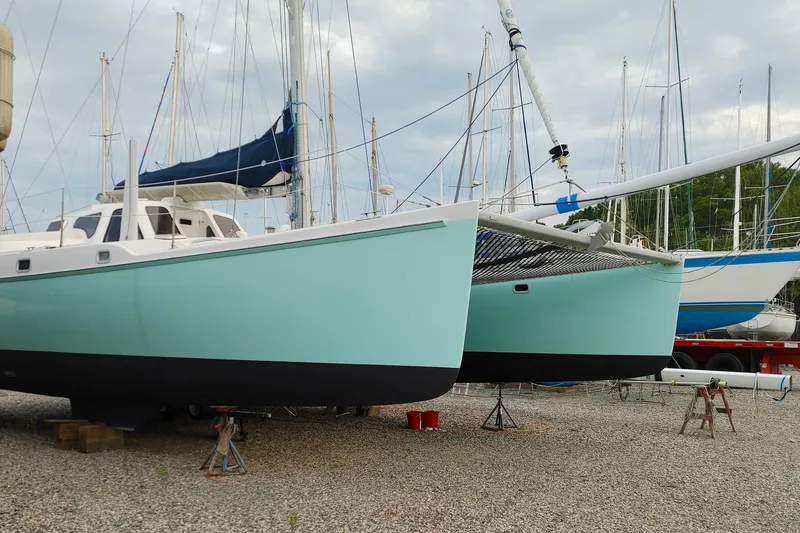 Slide: The Image of 2003 Chris White Atlantic 42 catamaran on dry dock, surrounded by other sailboats. - 5