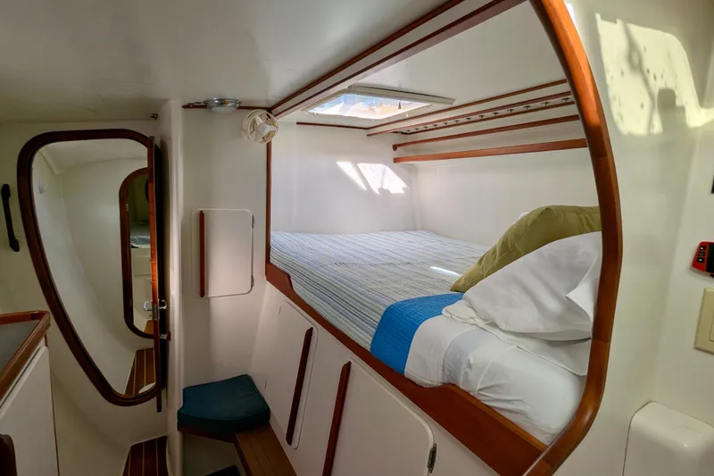 Slide: The Image of Cozy cabin interior of 2003 Chris White Atlantic 42 catamaran with bed and wooden accents. - 53