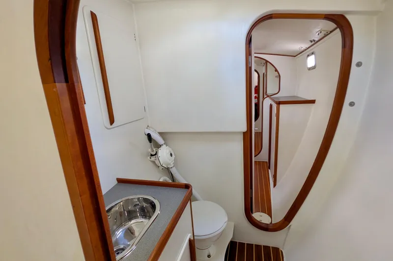 Slide: The Image of Interior of 2003 Chris White Atlantic 42 yacht, featuring a compact bathroom with wooden accents. - 56
