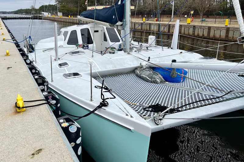 Slide: The Image of Catamaran Chris White Atlantic 42, 2003 model, docked at a marina. - 6