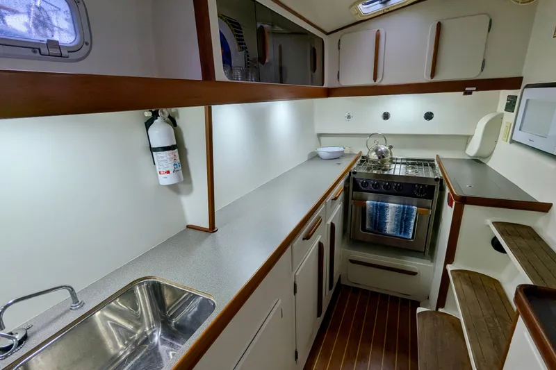 Slide: The Image of Modern galley kitchen in 2003 Chris White Atlantic 42 yacht, featuring stove and sink. - 63