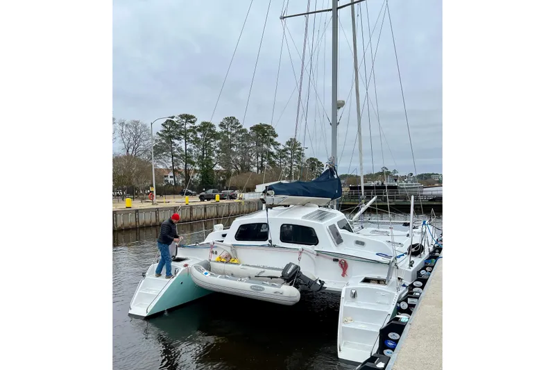 Slide: The Image of 2003 Chris White Atlantic 42 catamaran docked with a person on deck. - 7