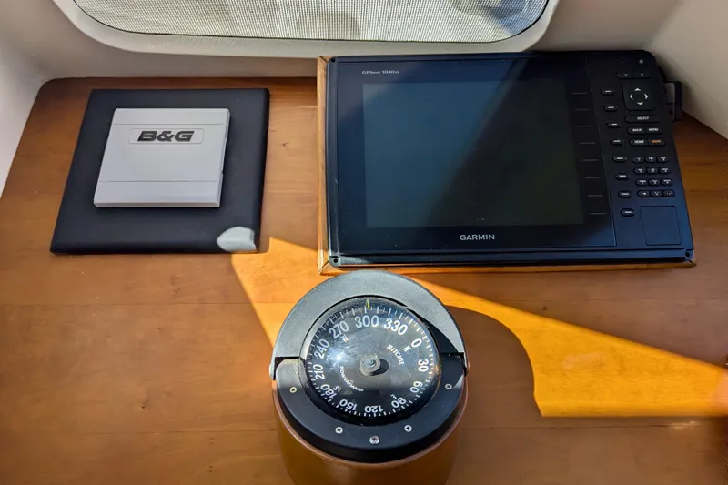 Slide: The Image of Navigation equipment on 2003 Chris White Atlantic 42, featuring Garmin GPS and compass. - 71