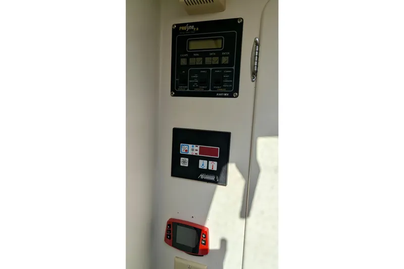 Slide: The Image of Control panel inside 2003 Chris White Atlantic 42 yacht, featuring various electronic displays and controls. - 75