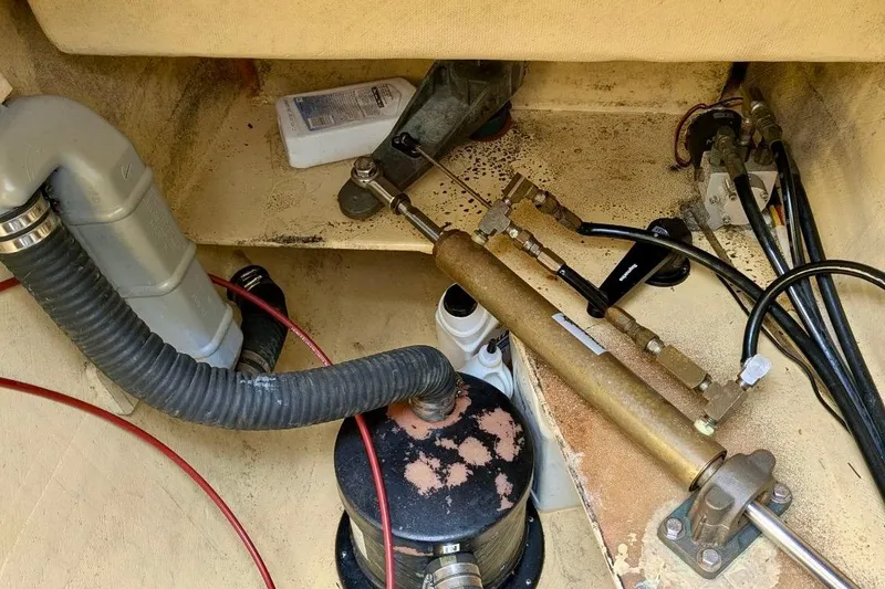 Slide: The Image of Engine compartment of 2003 Chris White Atlantic 42, showing mechanical components and hoses. - 85