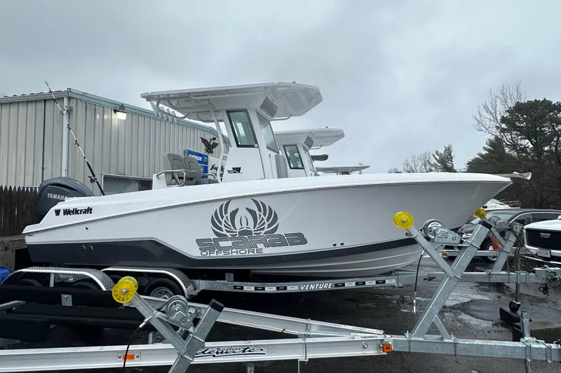 Slide: The Image of 2025 Wellcraft 243 Fisherman boat on trailer, featuring Scarab Offshore branding. - 1