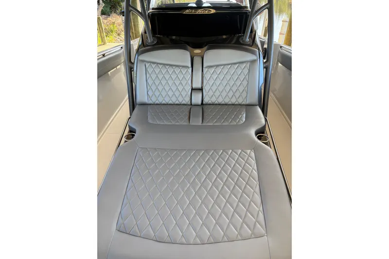 Slide: The Image of 2017 Nor-Tech 390 Sport Center Console interior with diamond-stitched gray seating. - 13