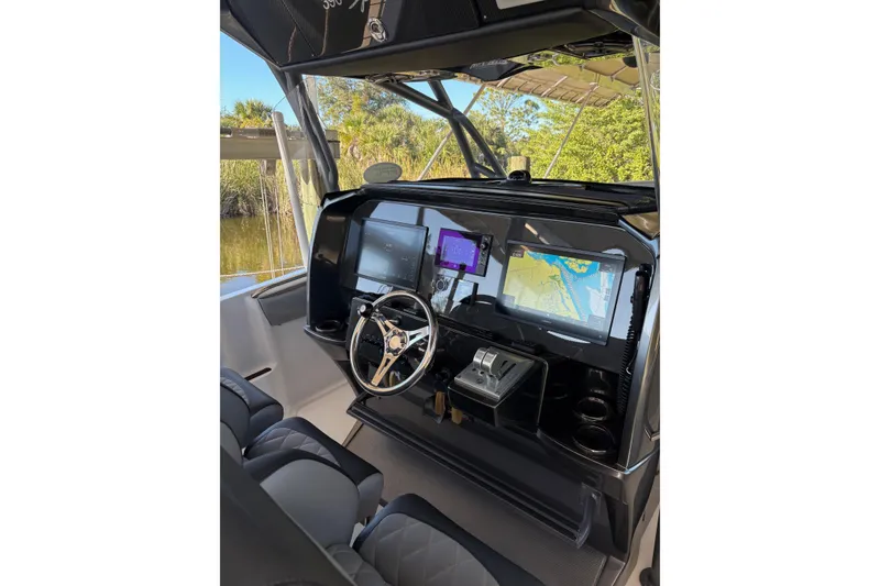 Slide: The Image of 2017 Nor-Tech 390 Sport Center Console helm with advanced navigation displays. - 14