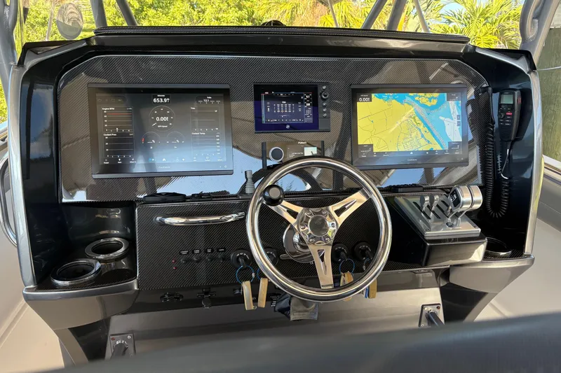 Slide: The Image of 2017 Nor-Tech 390 Sport Center Console dashboard with navigation and control systems. - 15