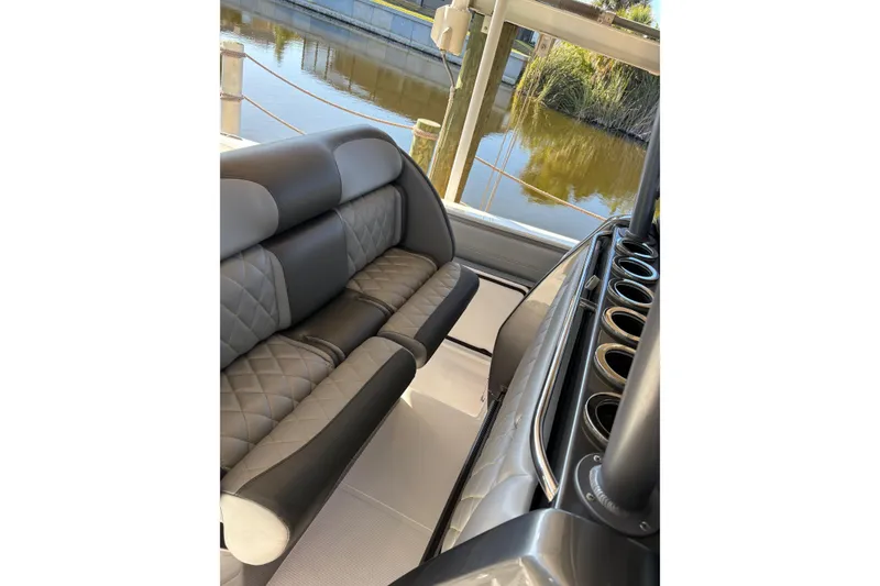 Slide: The Image of 2017 Nor-Tech 390 Sport Center Console interior with luxurious seating and cup holders. - 16