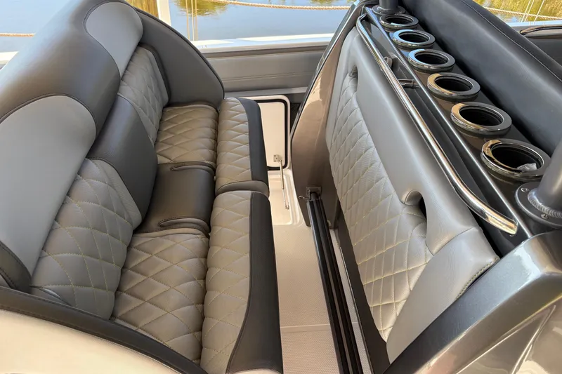 Slide: The Image of Luxurious seating on 2017 Nor-Tech 390 Sport Center Console with quilted upholstery and cup holders. - 17