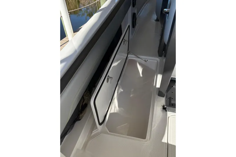 Slide: The Image of 2017 Nor-Tech 390 Sport Center Console storage compartment open on deck. - 23