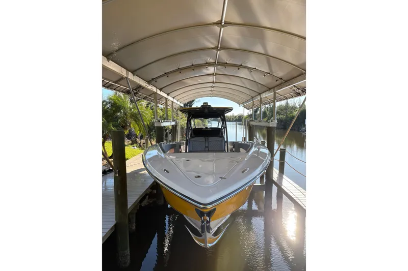 Slide: The Image of 2017 Nor-Tech 390 Sport Center Console boat docked under canopy. - 6