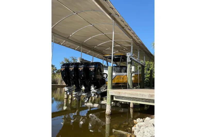 Slide: The Image of 2017 Nor-Tech 390 Sport Center Console with multiple outboard engines under a canopy. - 8