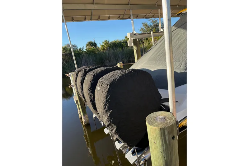 Slide: The Image of 2017 Nor-Tech 390 Sport Center Console with covered engines at dock. - 9