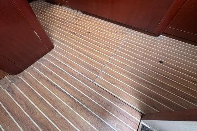 Slide: The Image of Teak flooring on 1996 Beneteau 50 yacht interior, showcasing elegant wood finish. - 107