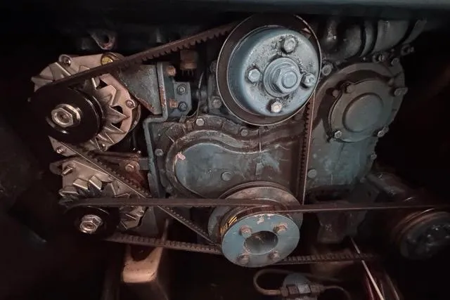 Slide: The Image of Engine components of a 1996 Beneteau 50 sailboat, featuring belts and pulleys. - 110