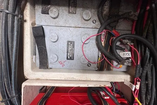 Slide: The Image of Battery compartment of a 1996 Beneteau 50 sailboat with cables and connections. - 114