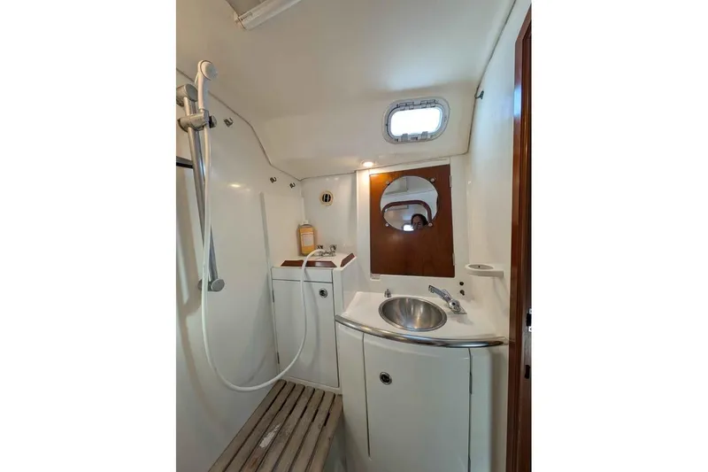 Slide: The Image of Beneteau 50 sailboat deck view, 1996 model, docked at marina with other boats. - 17