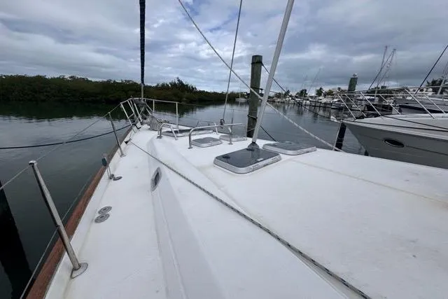 Slide: The Image of Deck view of a 1996 Beneteau 50 sailboat docked in a marina. - 20