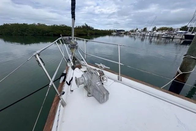Slide: The Image of Bow view of 1996 Beneteau 50 sailboat docked in a serene marina. - 22