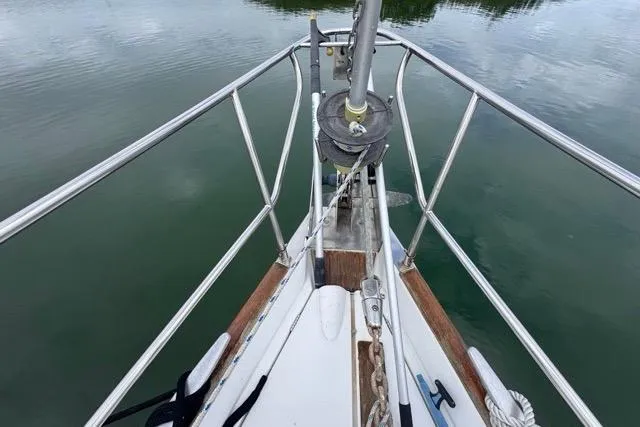 Slide: The Image of Bow of a 1996 Beneteau 50 sailboat with stainless steel railings on calm water. - 24