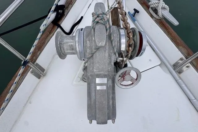 Slide: The Image of Anchor windlass on 1996 Beneteau 50 sailboat deck, featuring ropes and chains. - 25