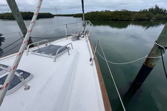Slide: The Image of Sailing yacht Beneteau 50 (1996) docked in calm waters, featuring a spacious deck. - 28