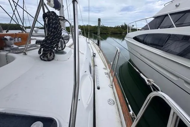 Slide: The Image of Sailboat deck view of 1996 Beneteau 50 docked beside another yacht. - 37
