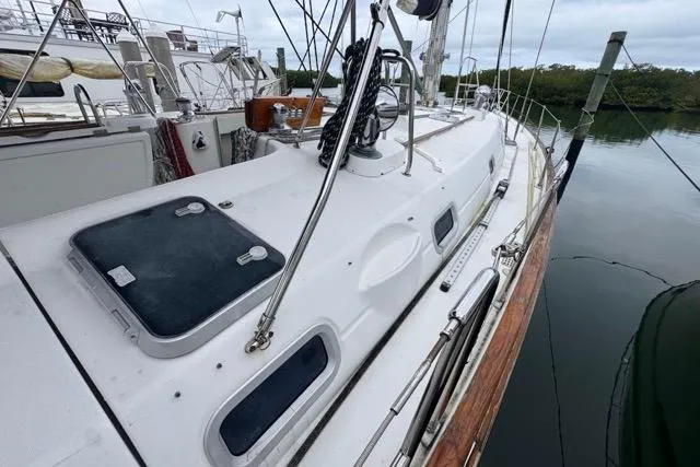 Slide: The Image of 1996 Beneteau 50 sailboat docked, showcasing deck and rigging details. - 38