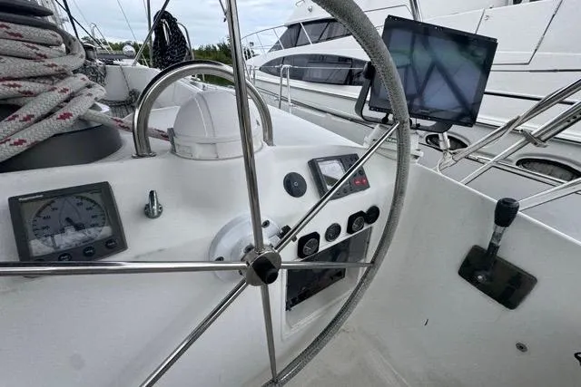 Slide: The Image of Cockpit view of 1996 Beneteau 50 sailboat with steering wheel and navigation instruments. - 39