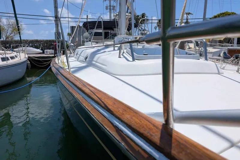 Slide: The Image of Beneteau 50 sailboat from 1996 with Suzuki outboard motor at dock. - 4