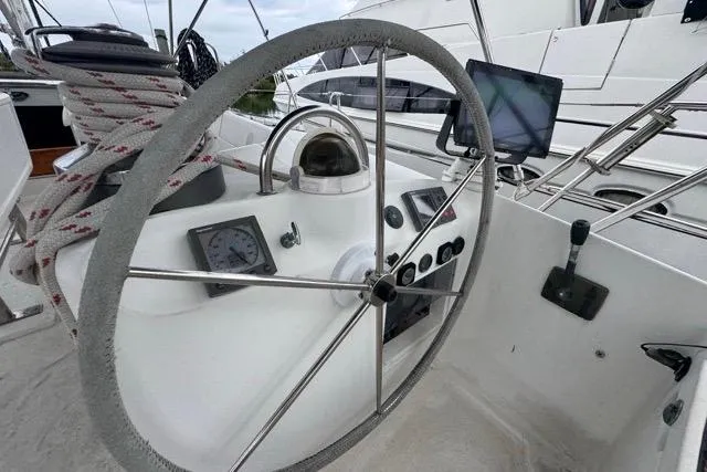 Slide: The Image of Steering wheel and controls of a 1996 Beneteau 50 sailboat cockpit. - 42