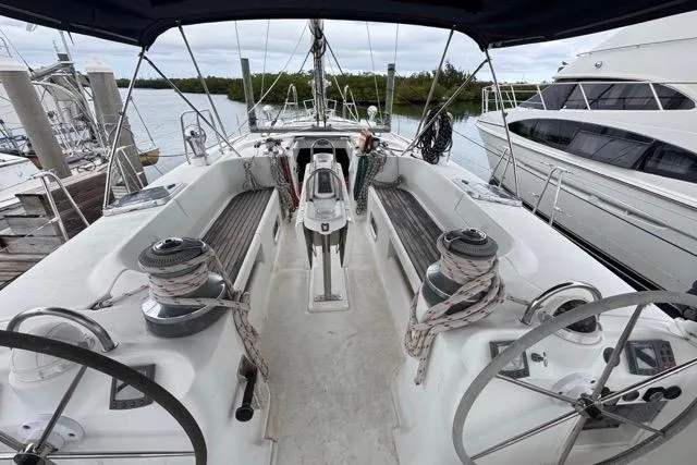 Slide: The Image of Cockpit view of a 1996 Beneteau 50 sailboat docked at a marina. - 44