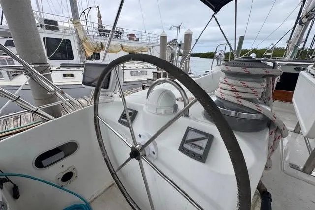 Slide: The Image of Helm of 1996 Beneteau 50 sailboat with navigation instruments and rope winch. - 45